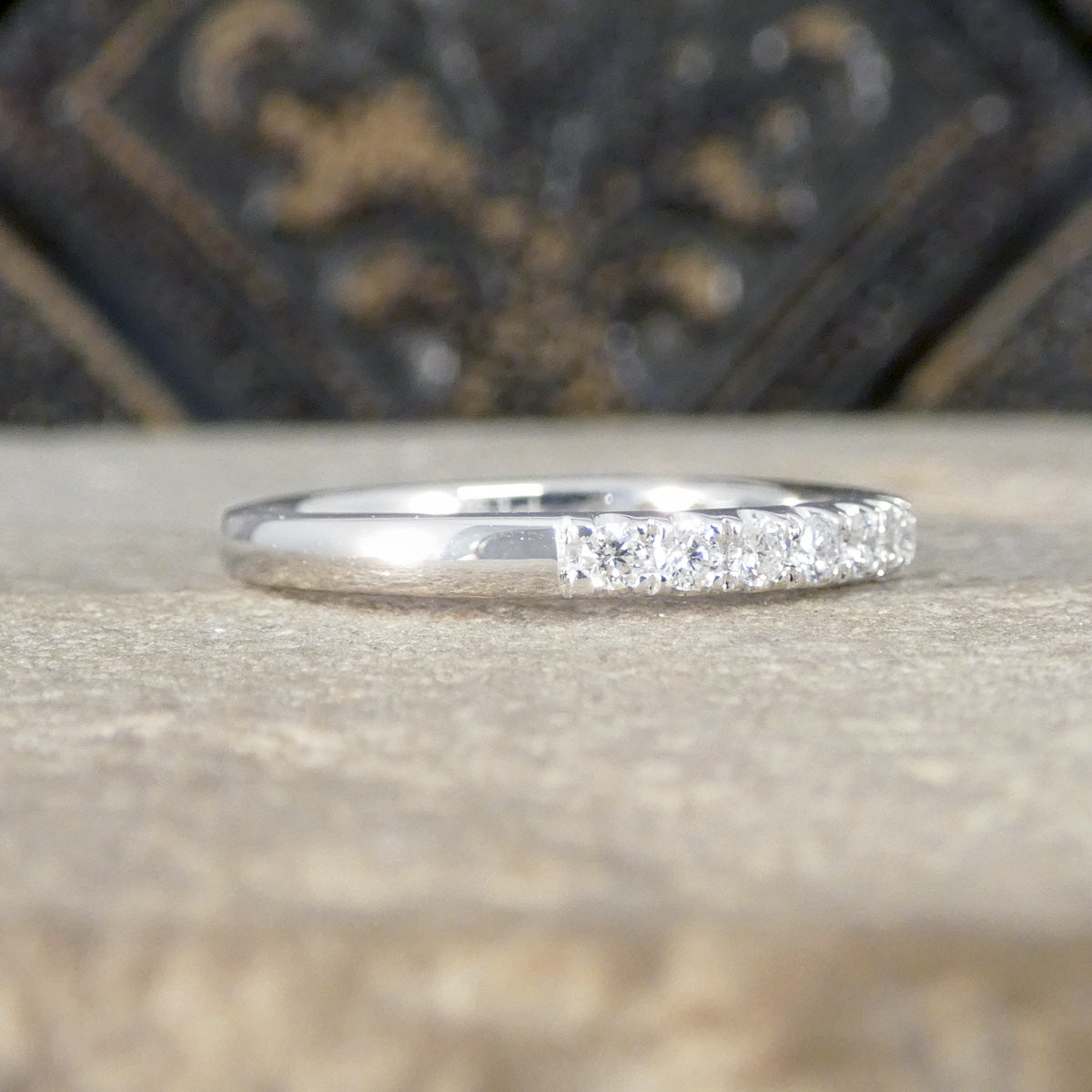 Silver ring with a diamond on a textured surface