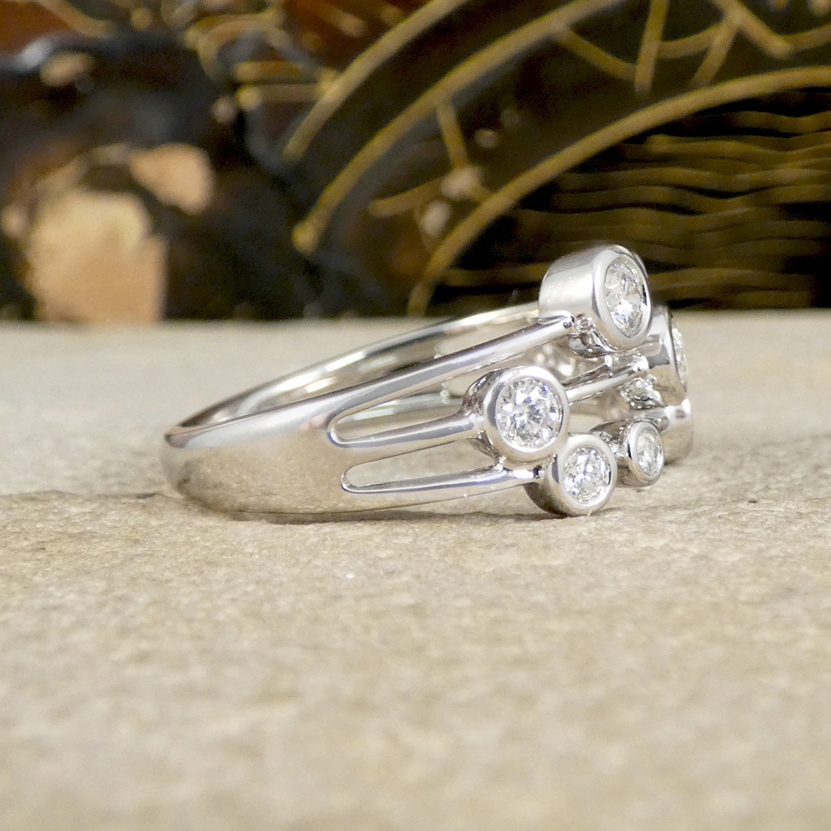 Platinum ring with diamond stones on a textured surface