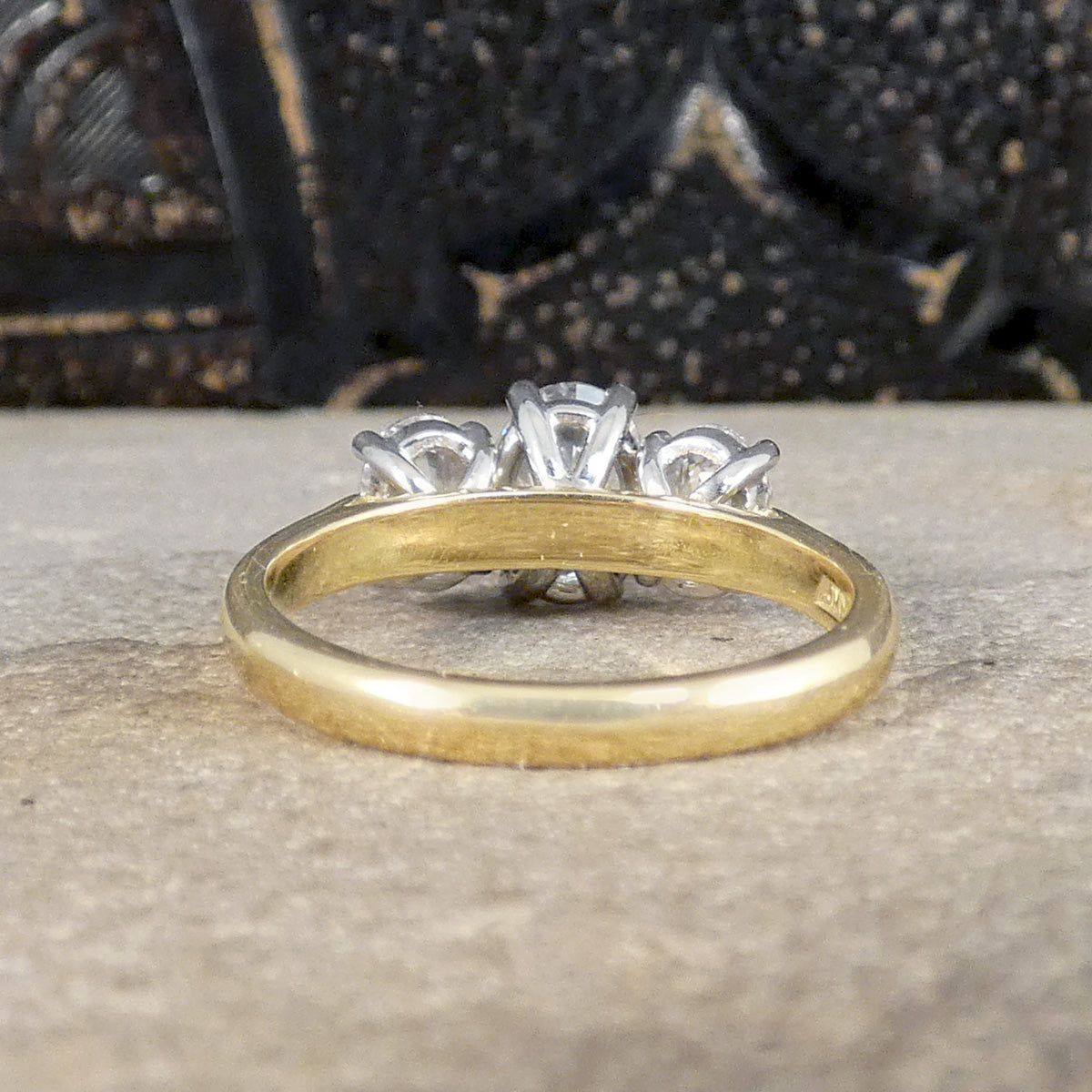 Back view of oval cut diamond three stone engagement ring showing plain polished 18ct yellow gold band and seeing the back of the wed fit design.