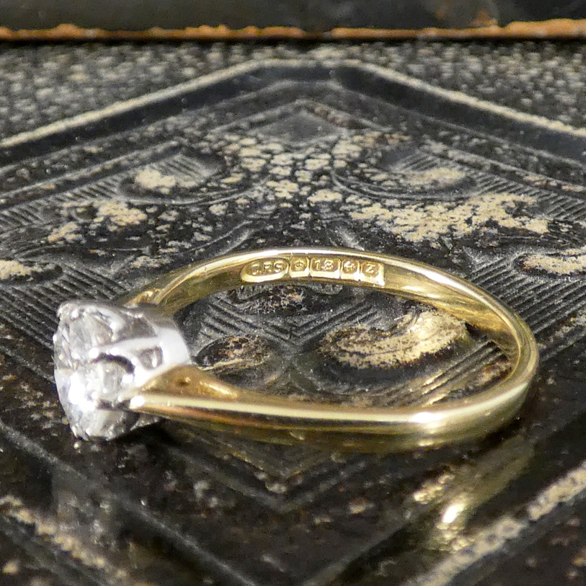 Hallmarks on the inner band on vintage solitaire ring showing it was made in Birmingham C1999 in 18ct Yellow Gold.