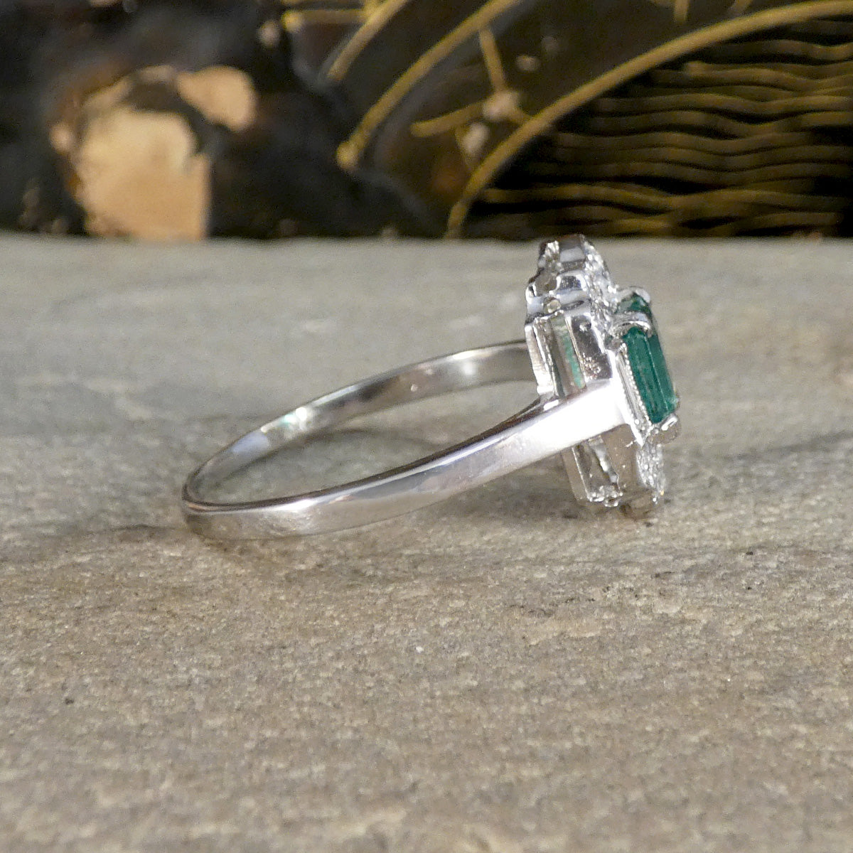 Art Deco Style Emerald and Diamond Cluster ring shown from the side