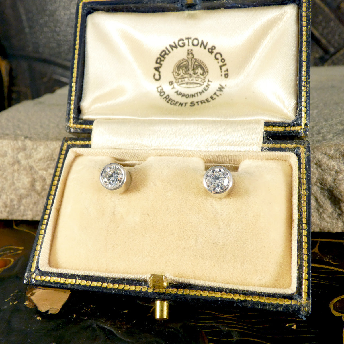 A classic pair of Bezel set Diamond Stud Earrings in Platinum holding 0.80ct with a GIA cert and bright E Colour grading. Shown in vintage box.