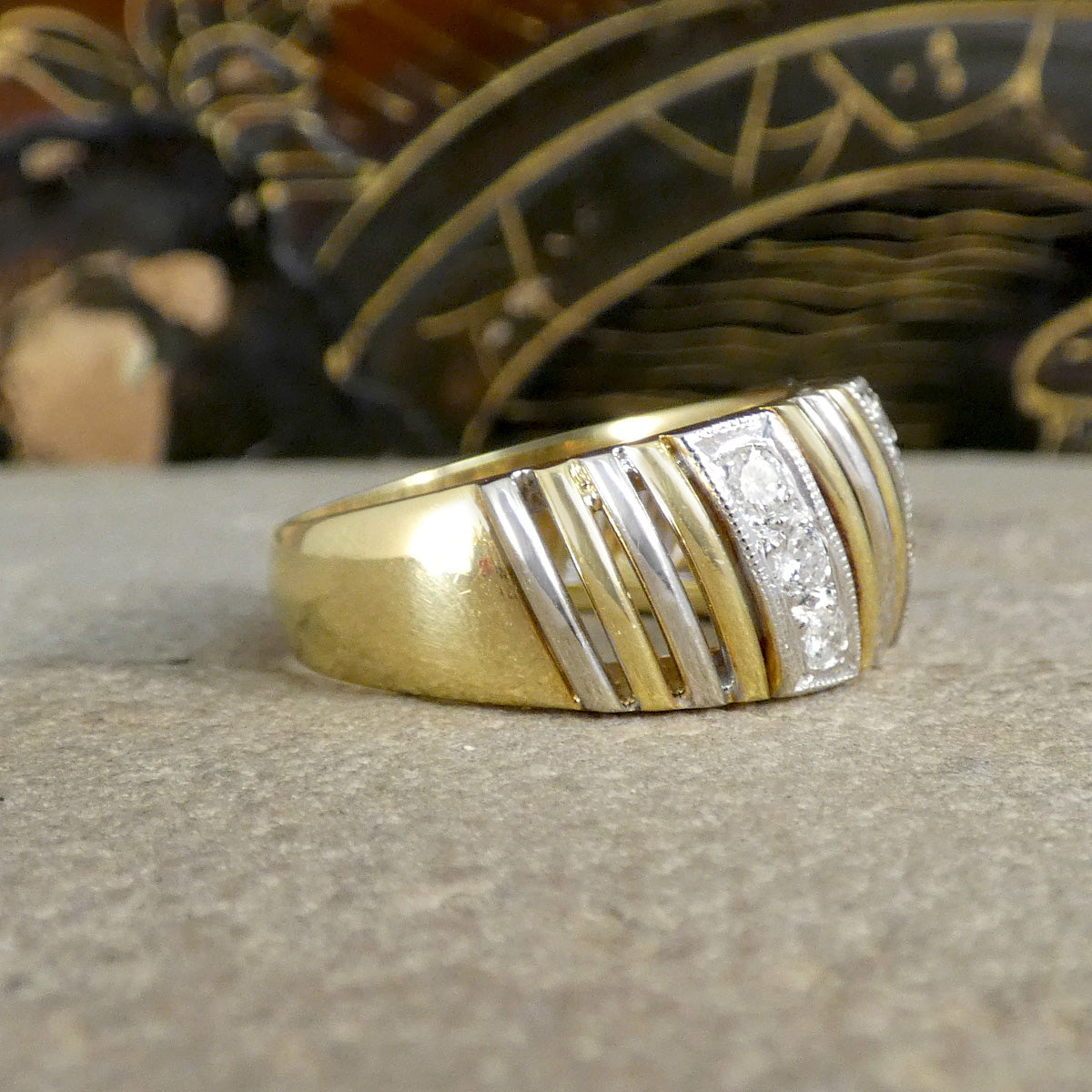 side view of chunky gold band with white gold stripes