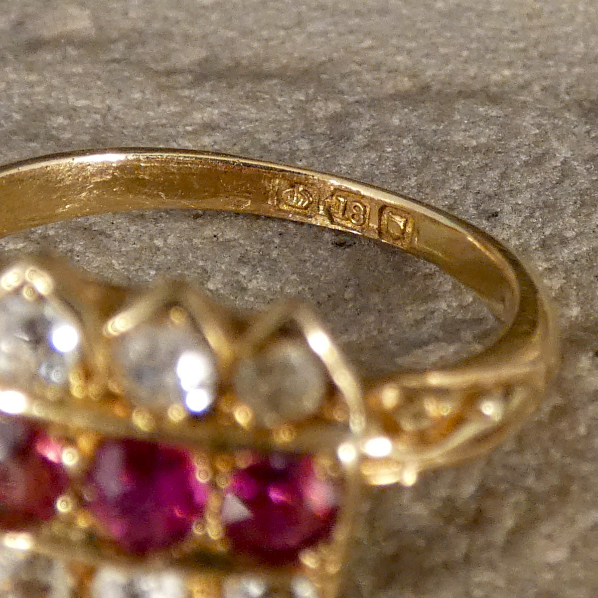 Large old hallmarks on the inner band showing 18ct gold and London.