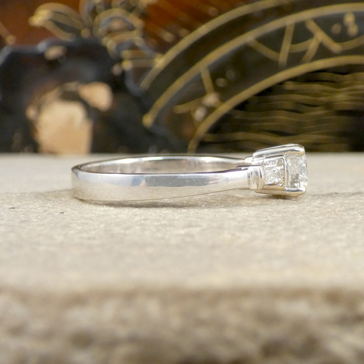 Silver ring with a diamond on a textured surface