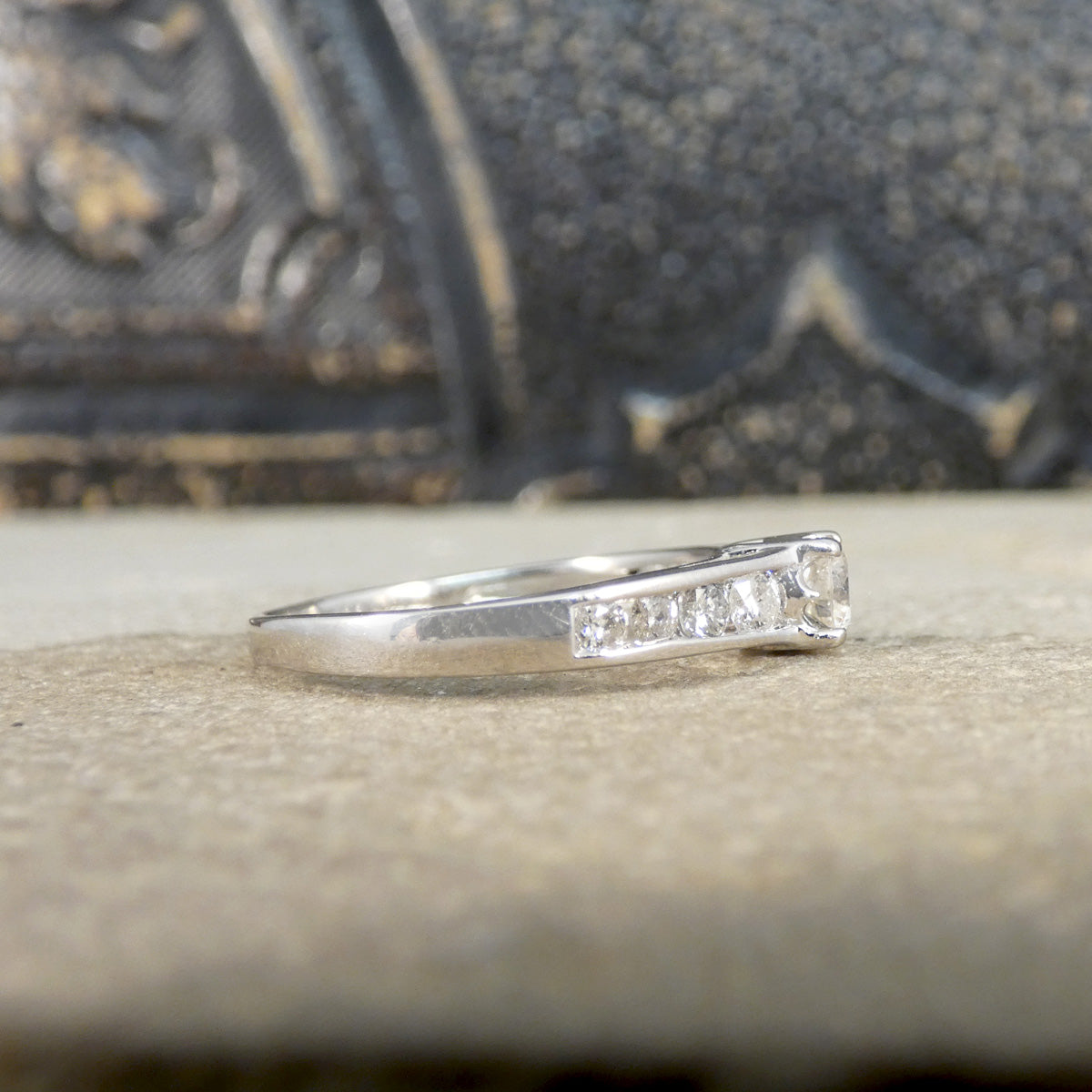 White Gold ring with small diamonds on a textured surface
