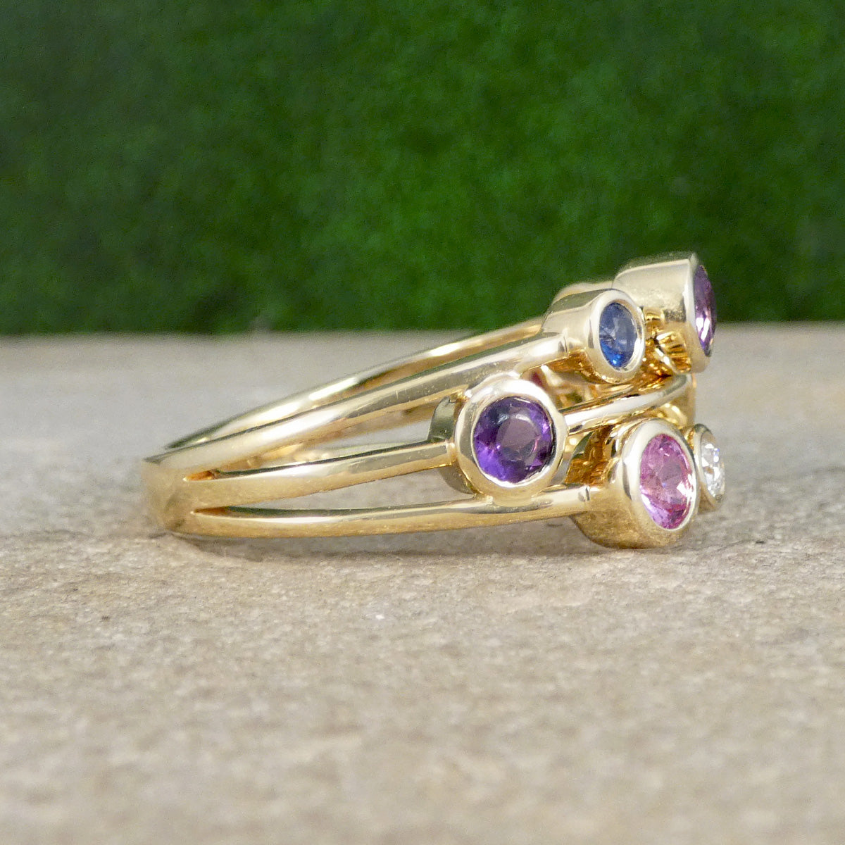 Multi Gem set bubble ring in yellow gold set along three strands