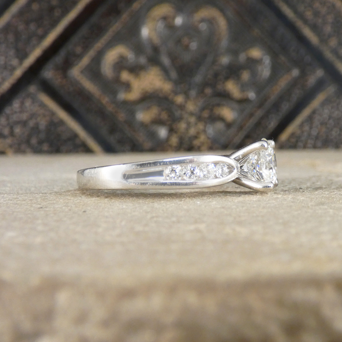 Platinum ring with a diamond on a textured surface