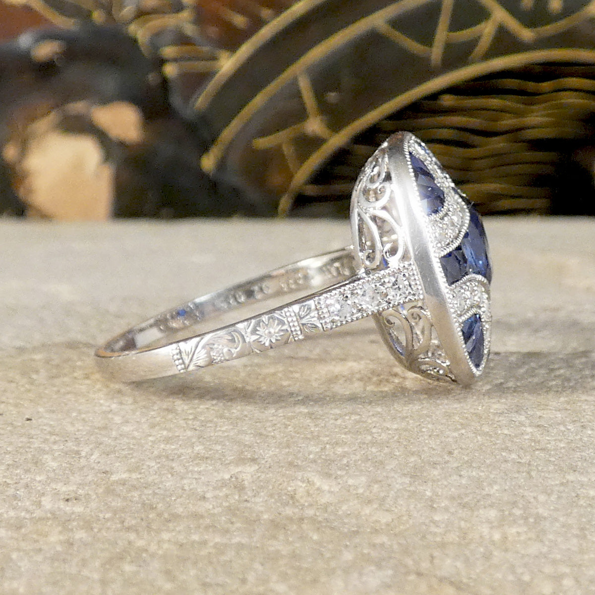 A beautifully detailed shoulder with flowers engraved half way around the band and diamonds set in the shoulders.