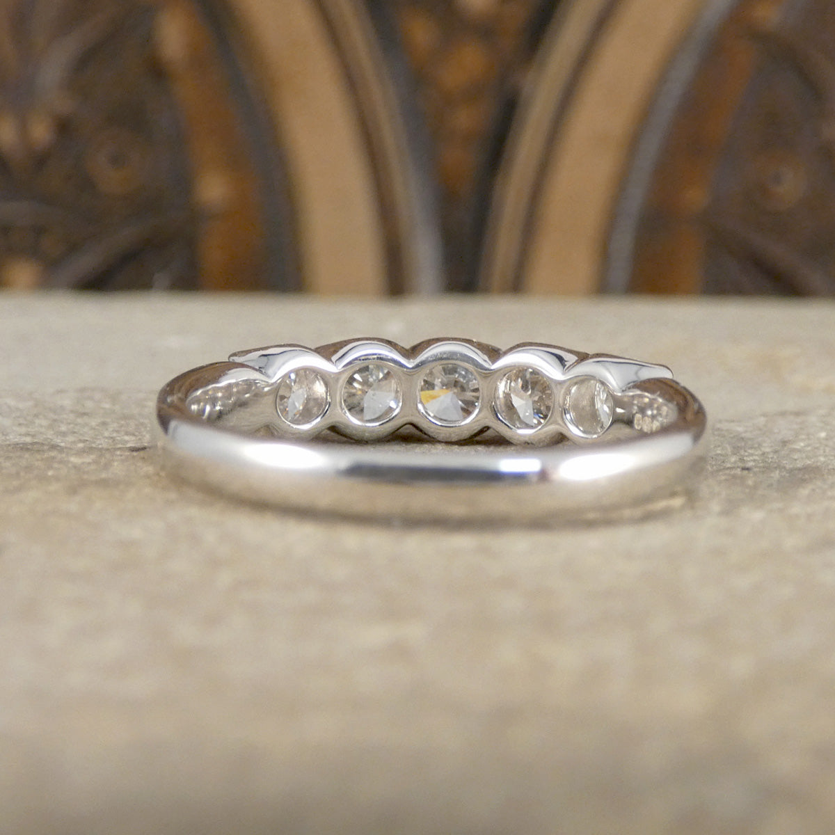 Silver ring with diamonds on a textured surface