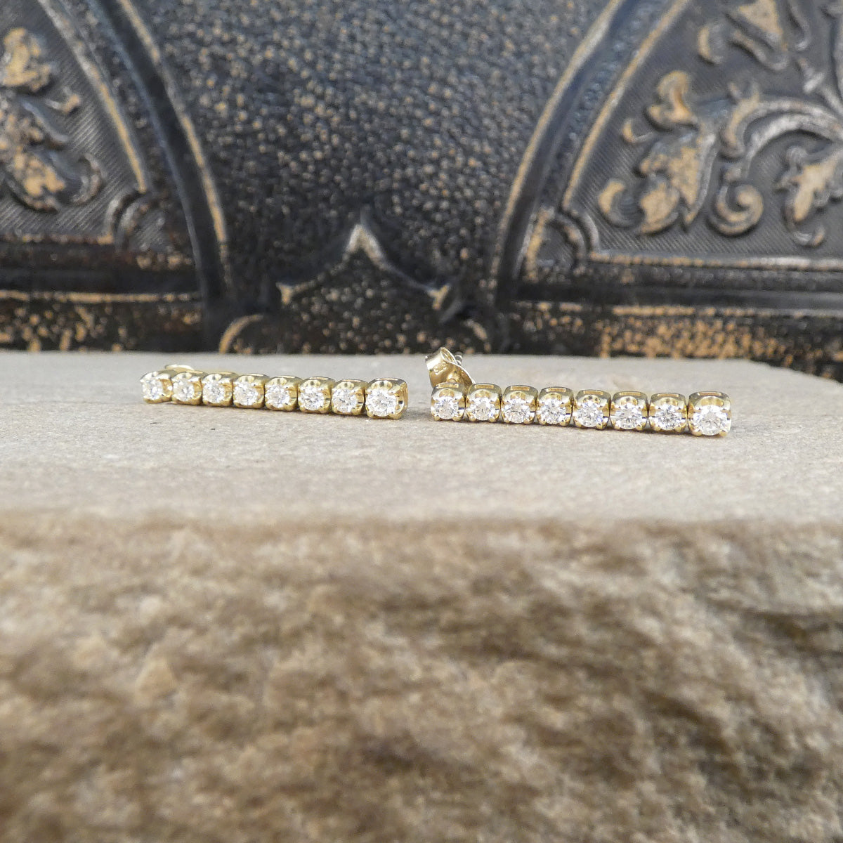 Diamond drop earring sin 9ct yellow gold on a stone.