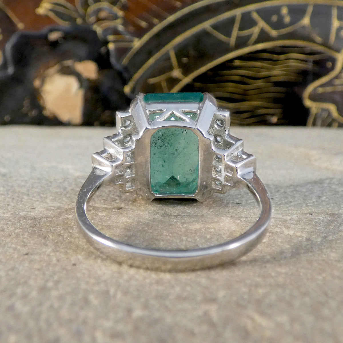 Back view of Emerald and Diamond dress cocktail ring showing gallery setting and plain polished platinum band.