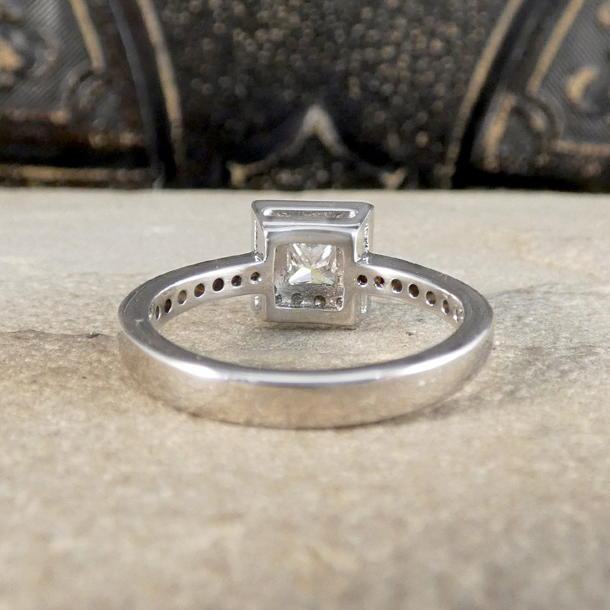 Engagement ring with a diamond on a textured surface