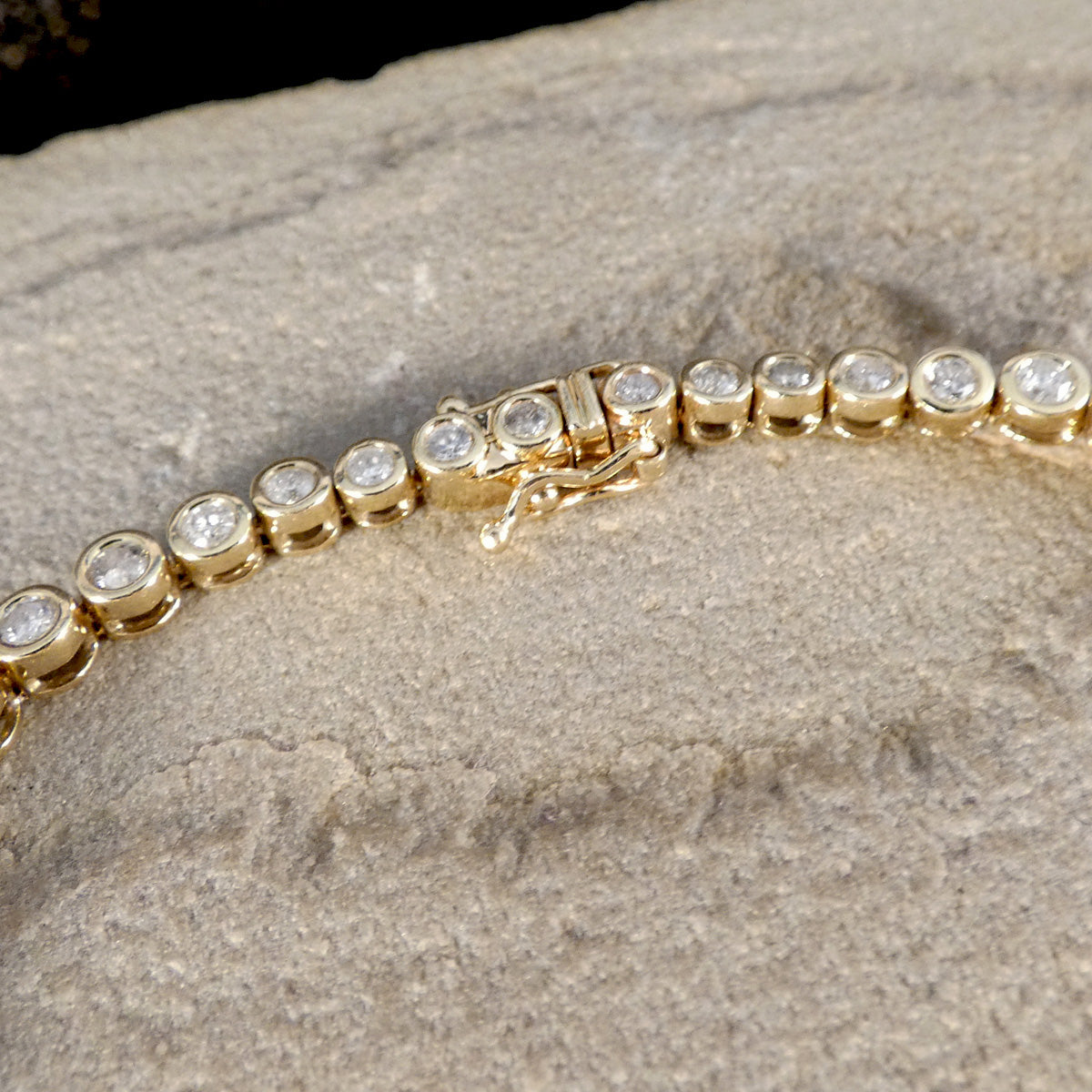 A diamond set clasp with figure eight safety clasp and snap lock.