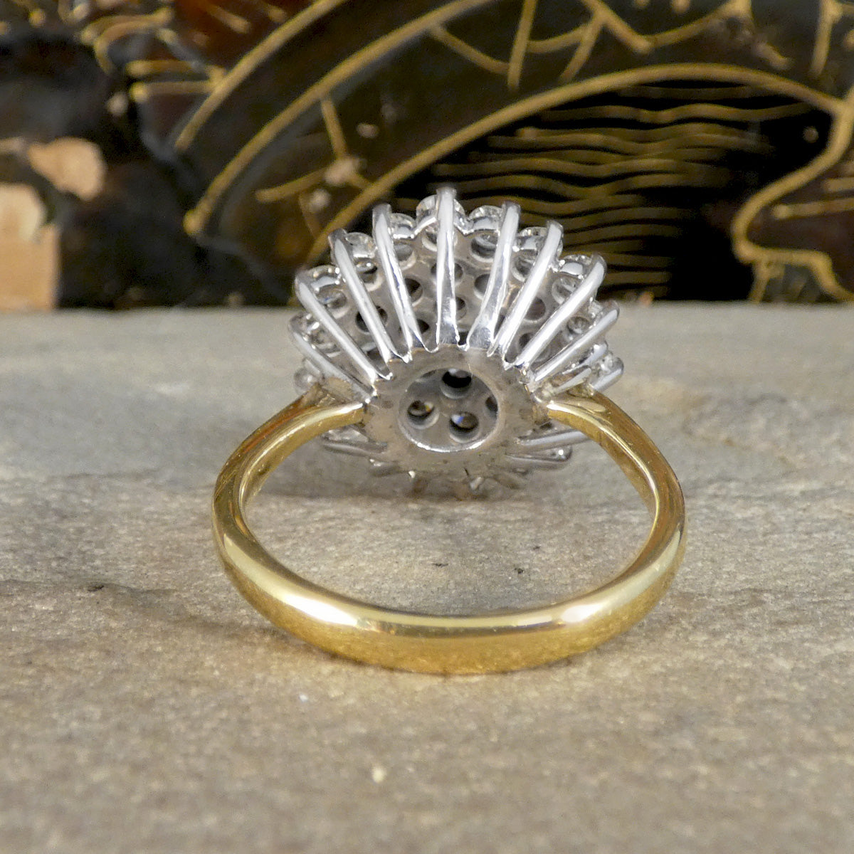 white gold ring with decorative design on a textured surface