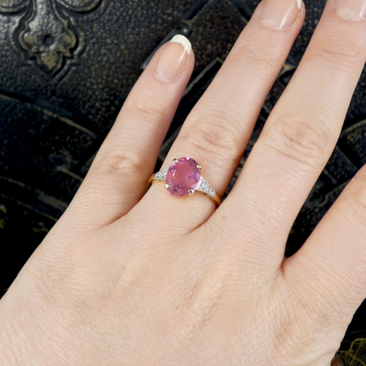 A beautiful and bright pink tourmaline and diamond Art Deco replica ring shown on the finger to see how it looks when worn.