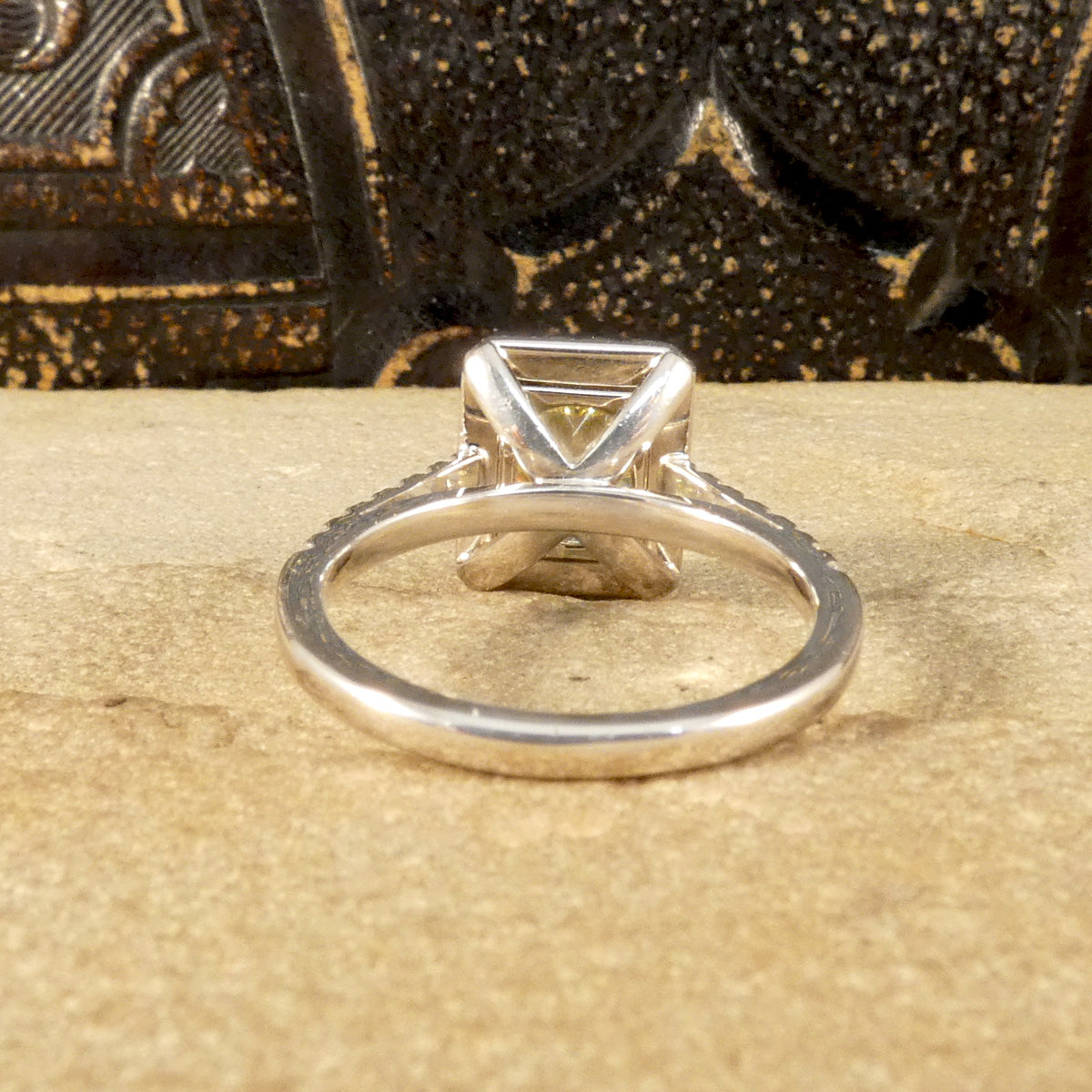 Back view of Natural Yellow Radiant Cut Diamond with GIA grading in a four claw setting. Surrounded by a halo of bright white Diamonds and Diamond set shoulders in 18ct White Gold. Perfect engagement ring.