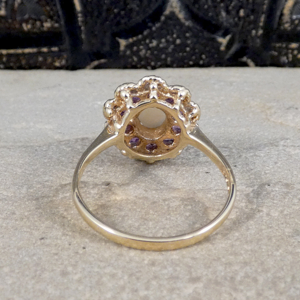Back view of opal and amethyst cluster ring, showing rope detailed surround.