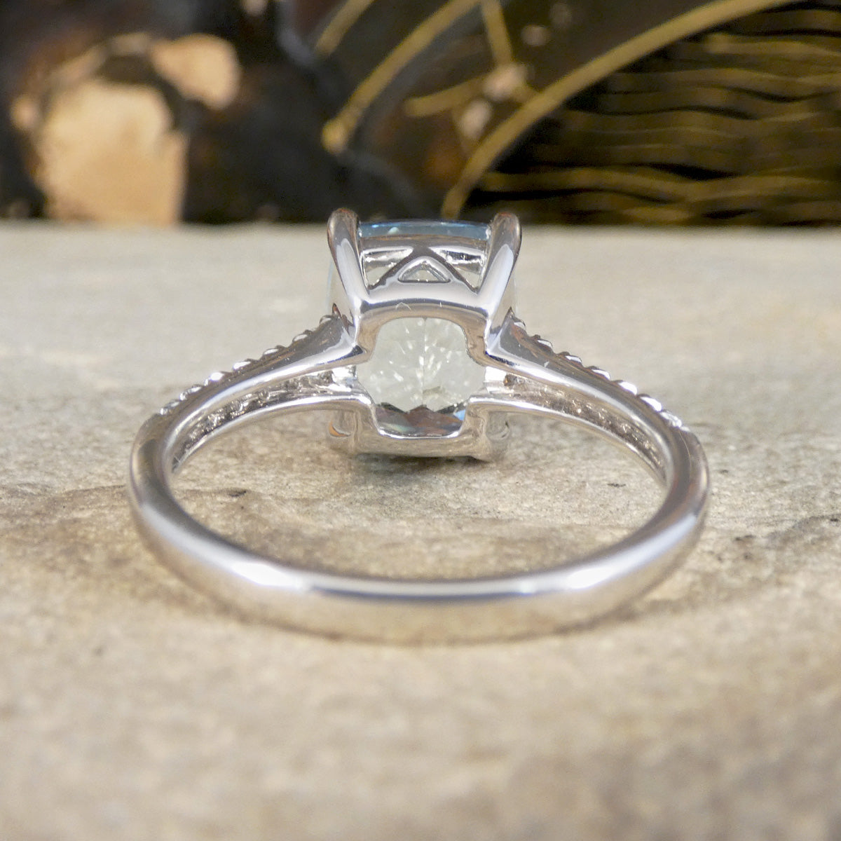 Silver ring with a diamond on a textured surface