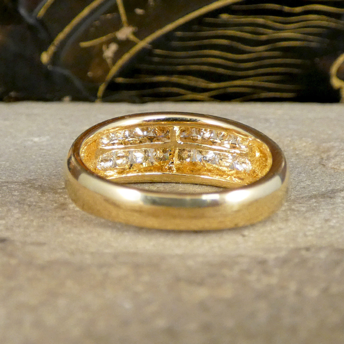 A diamond ring in yellow gold shown from behind