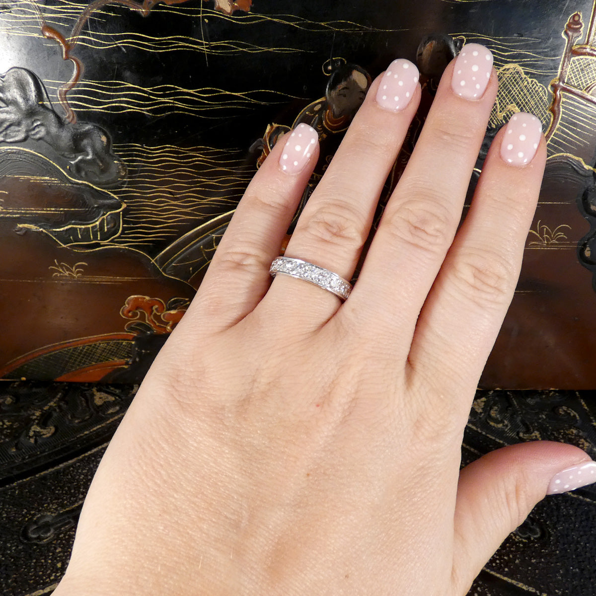 A full diamond eternity ring in 18ct white gold. Displayed on the finger to see when worn