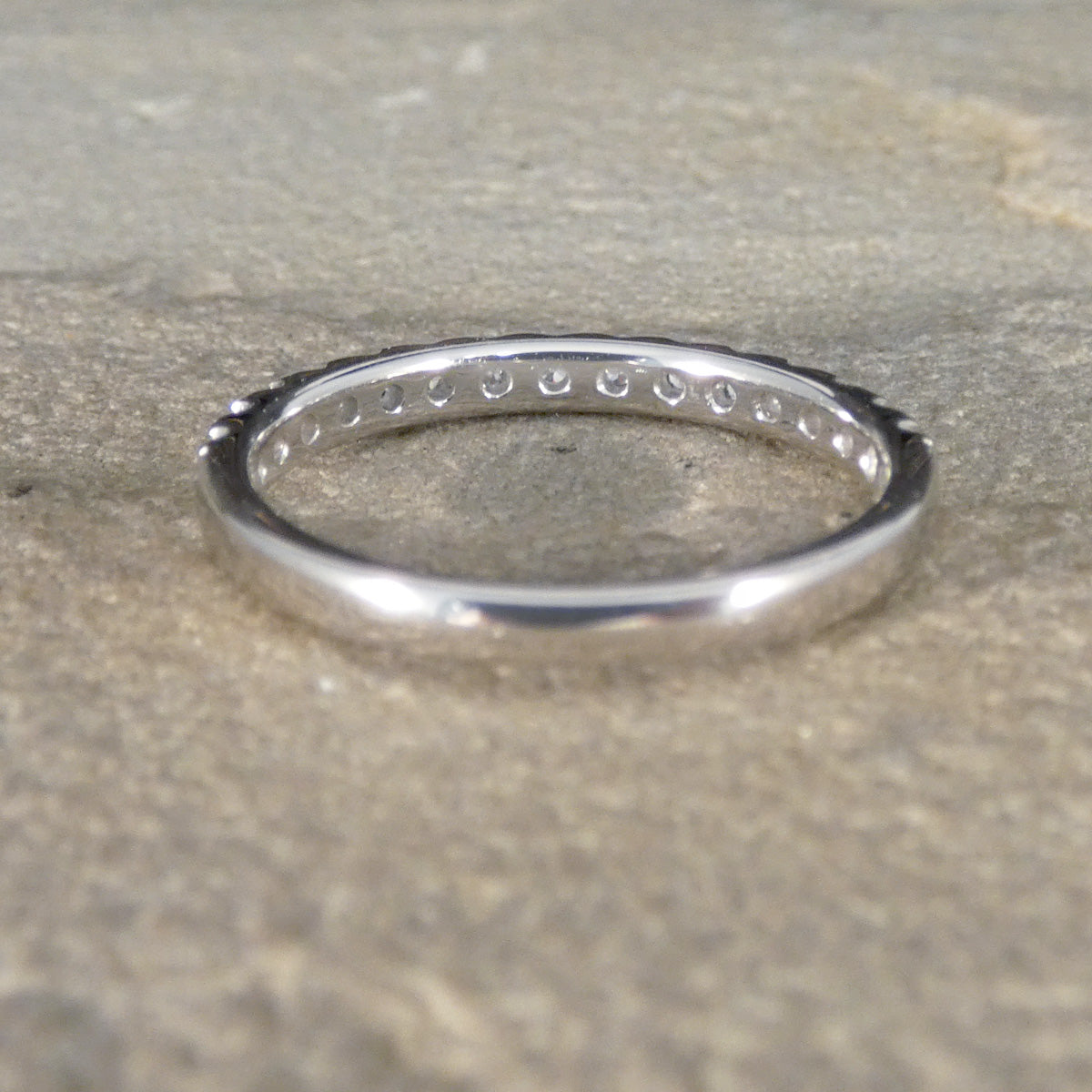 Silver ring on a textured beige surface