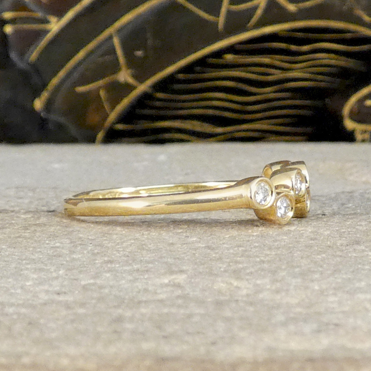 Side view of diamond set bubbled ring in yellow gold.