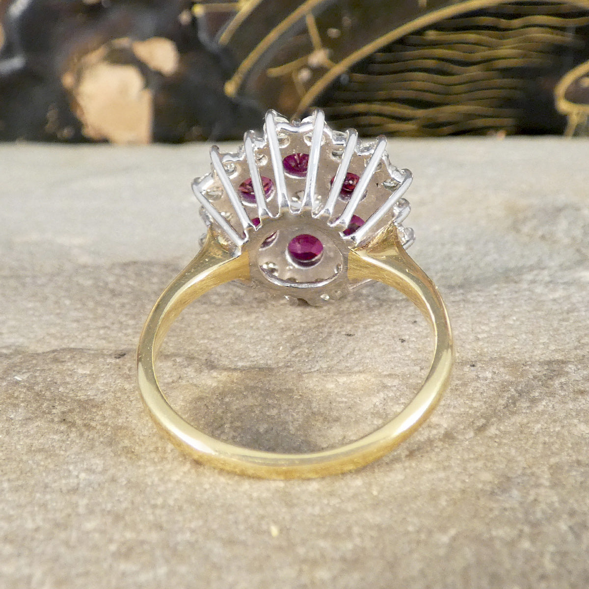 Gold ring with gemstones on a textured surface