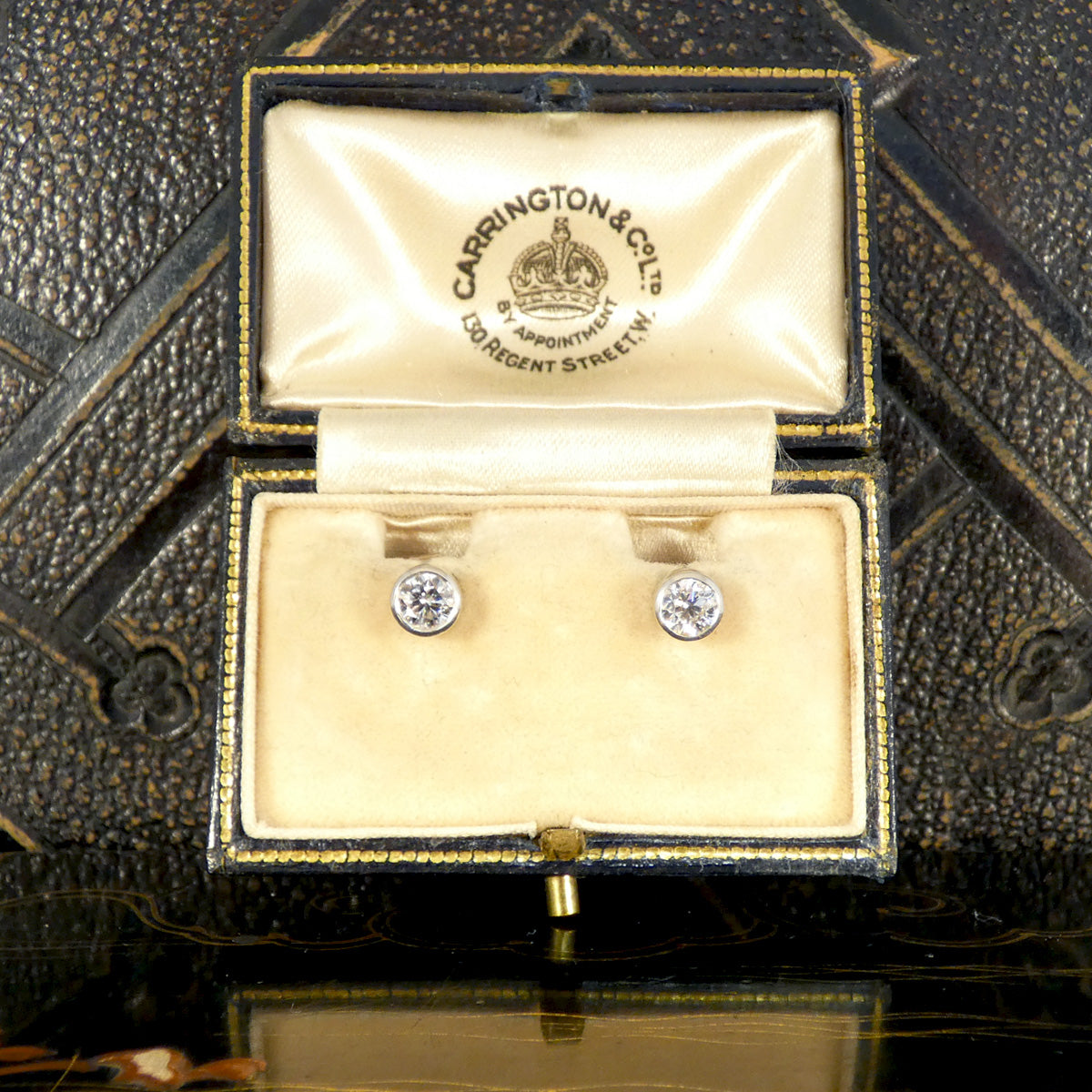 The perfect and classic gift of a pair of diamond bezel set stud earrings in platinum. Bright and graded E in colour.