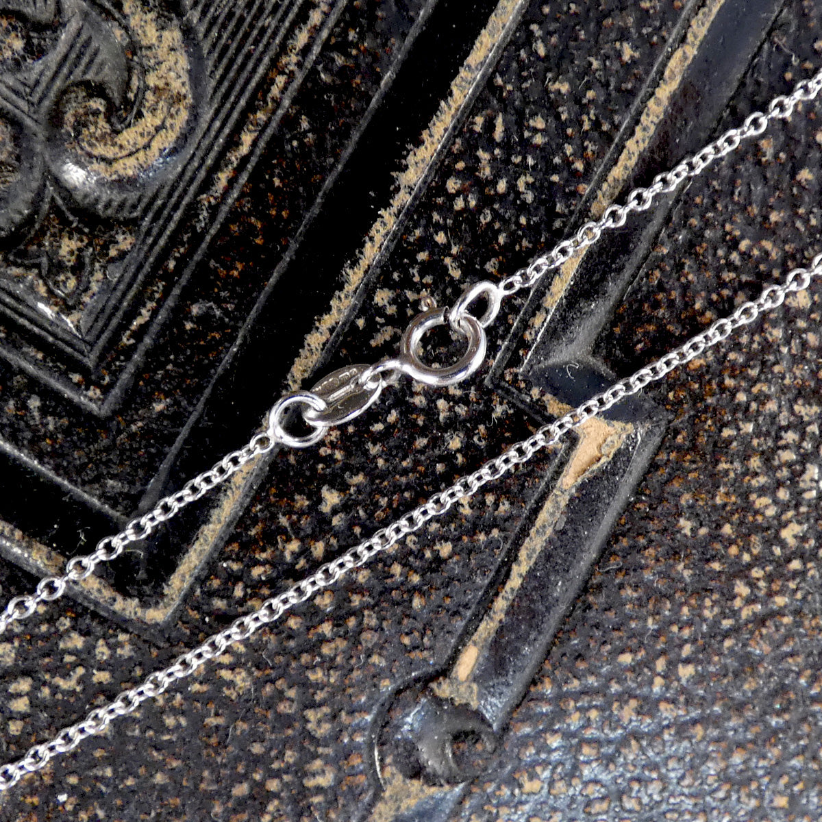 white gold chain with a bolt clasp.