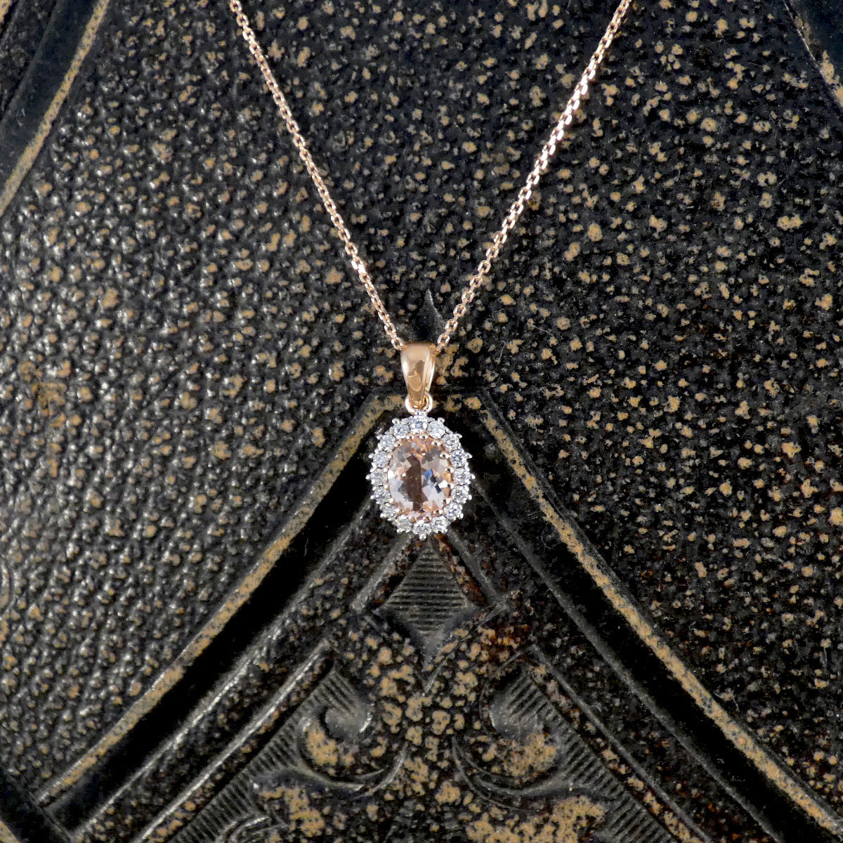 Diamond pendant necklace on a textured black background