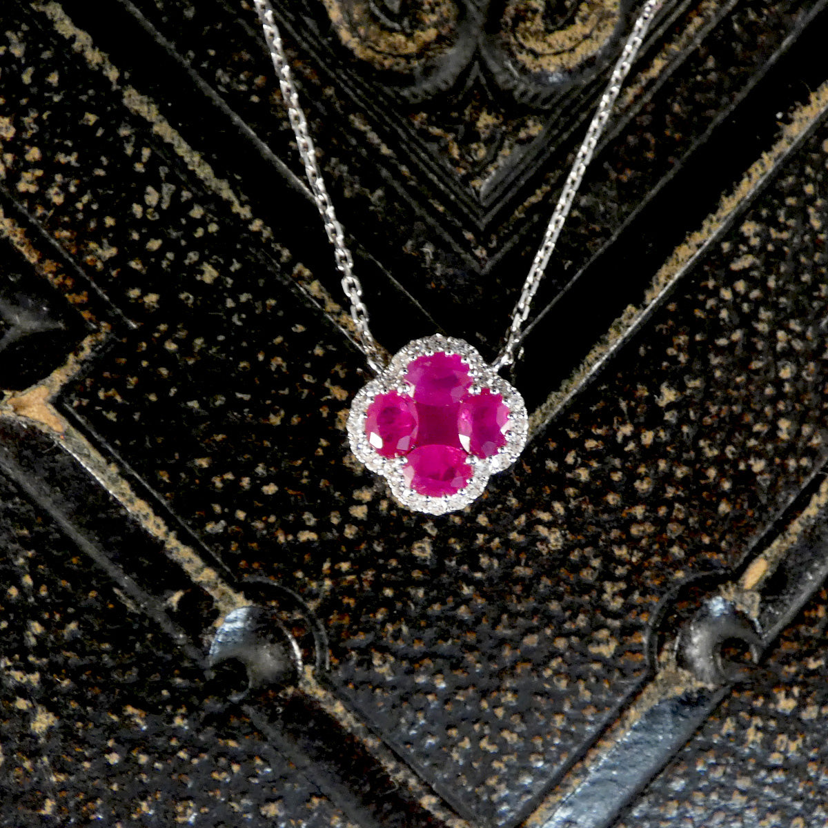 Close up shot of ruby and diamond pendant.