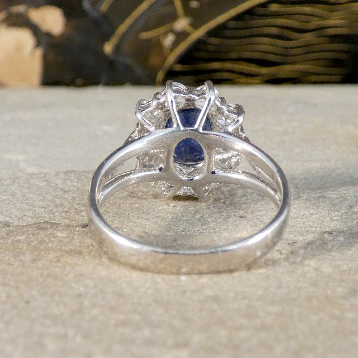 Silver ring with a blue gemstone on a textured surface