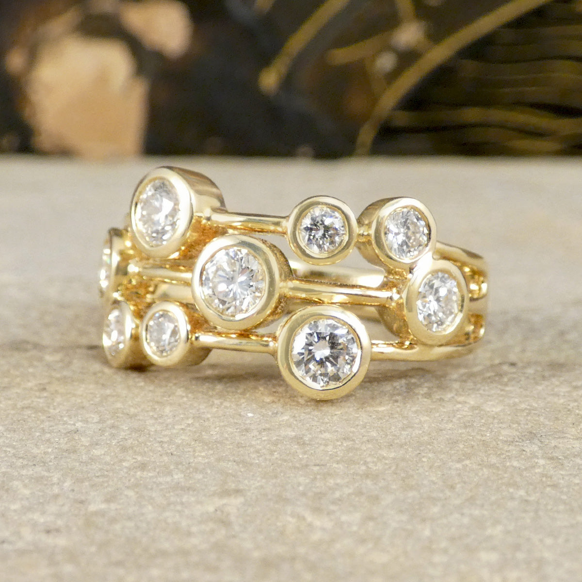 Gold ring with diamond stones on a neutral background