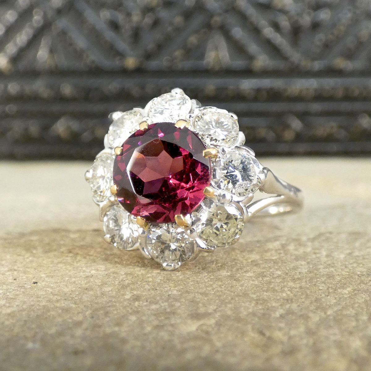 2.00ct Pyrope Garnet and 1.40ct Brilliant Cut Diamond flower cluster ring in 18ct White Gold with Yellow Gold claws on the Garnet. The garnet showing a bright pinky red hue.