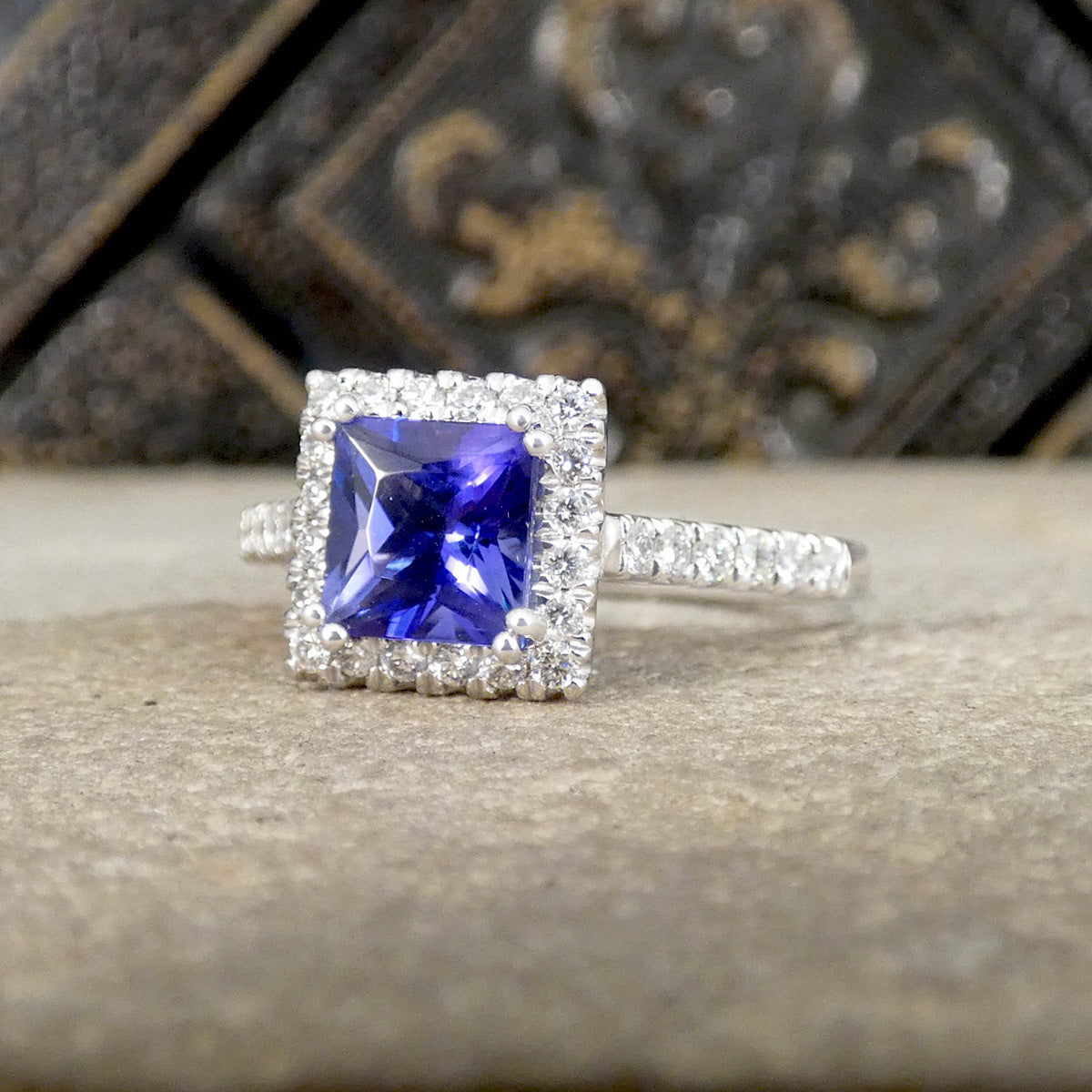 Silver ring with a blue gemstone on a textured surface