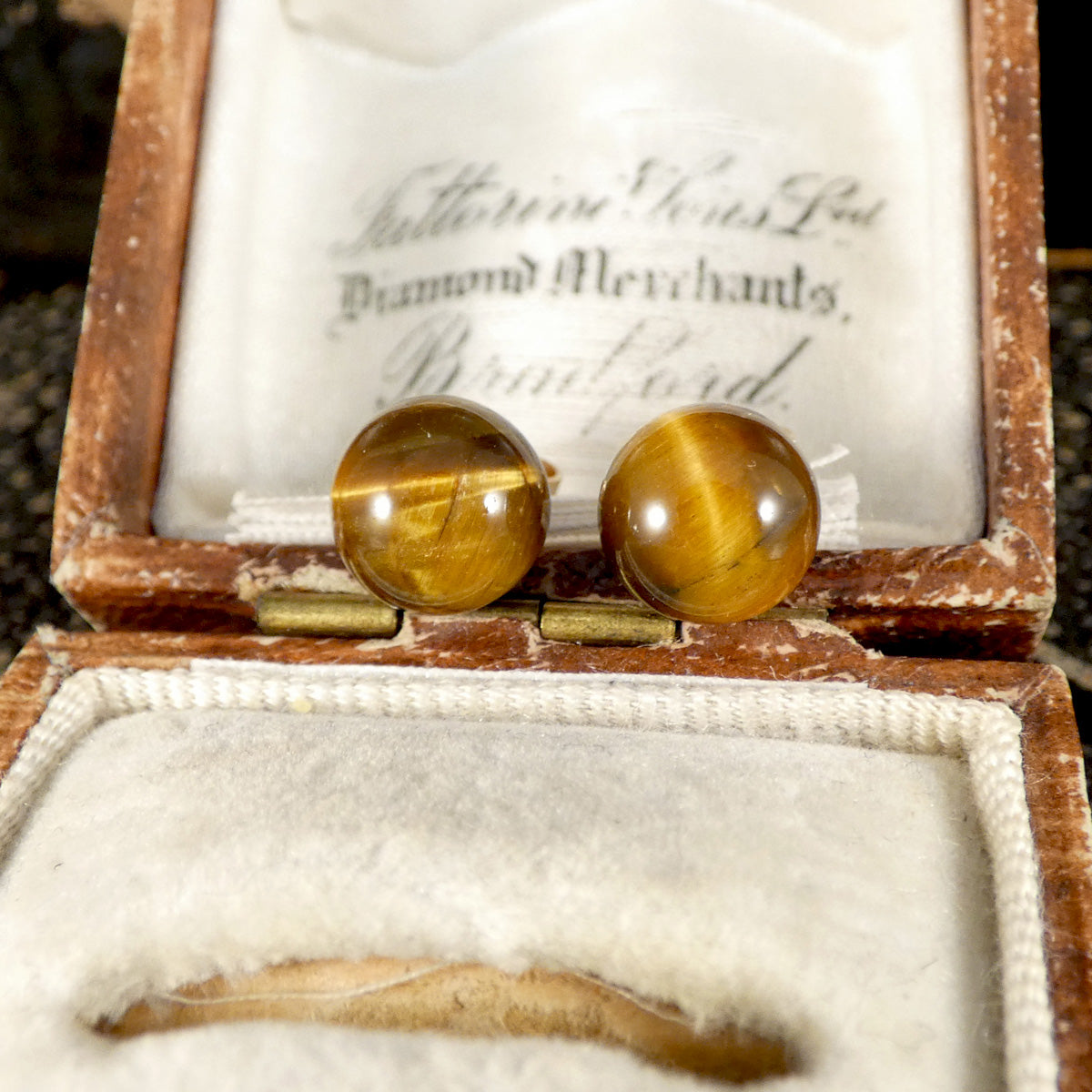A pair of stud earrings in a vintage box.