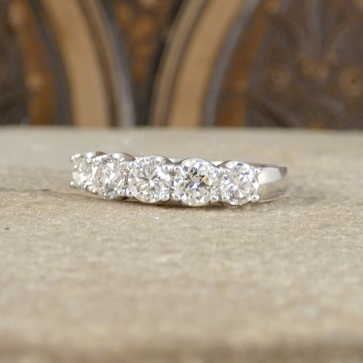 Diamond ring on a stone surface with a blurred background