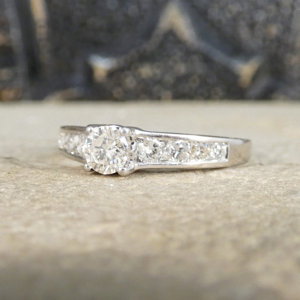 Diamond ring on a textured surface with a blurred background