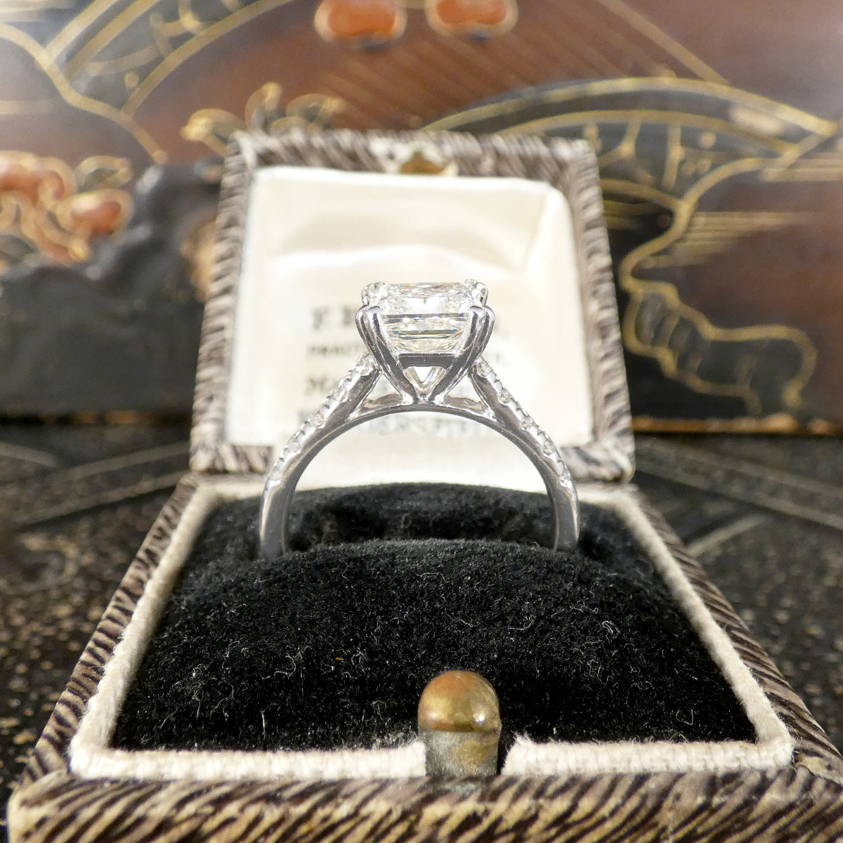 A gorgeous Princess cut Diamond Solitaire ring with diamond set shoulders in 18ct White Gold, the perfect engagement ring. Showing from the side profile to see wedfit design and high setting.