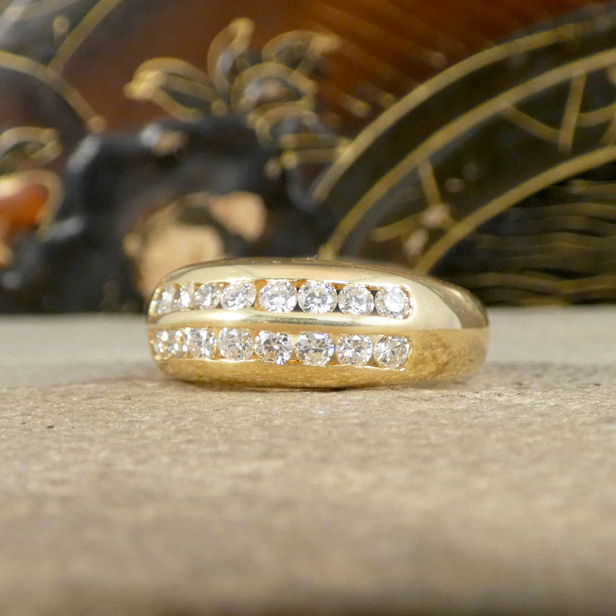A channel set diamond double row ring in yellow gold
