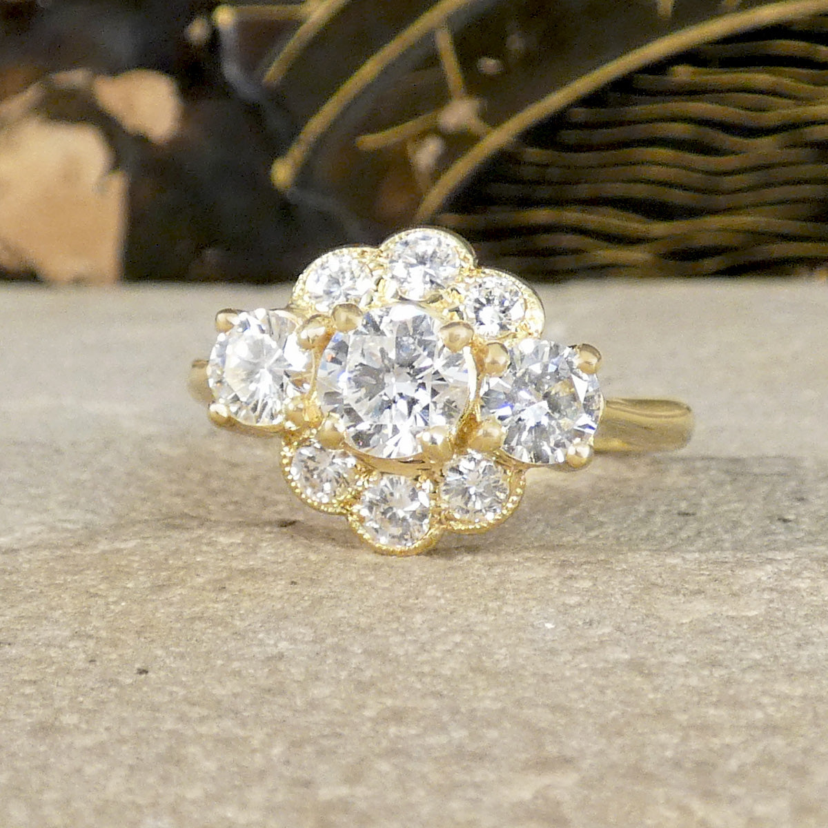 Gold ring with diamond cluster on a textured surface