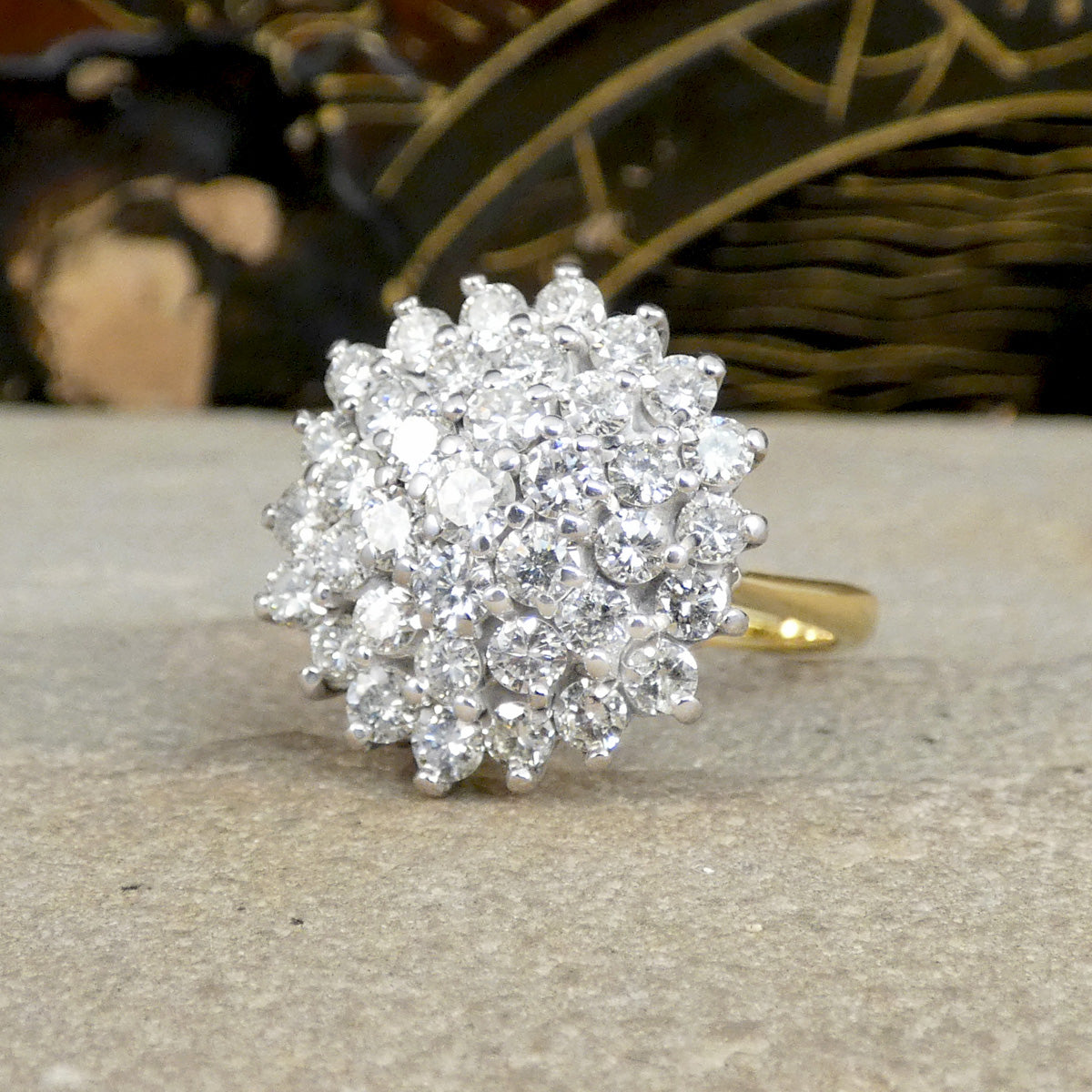 Diamond ring on a textured surface with blurred decorative background