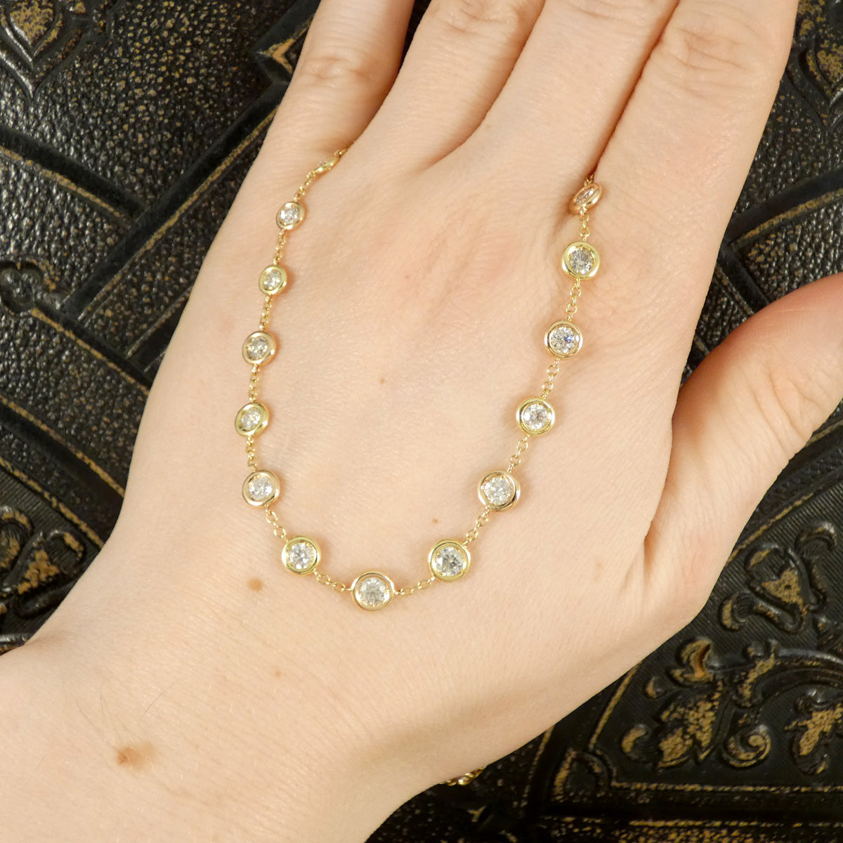4.55ct Diamond Spectacle Set Spaced Necklace in 18ct Rose and Yellow Gold shown on the hand to see size ratio.