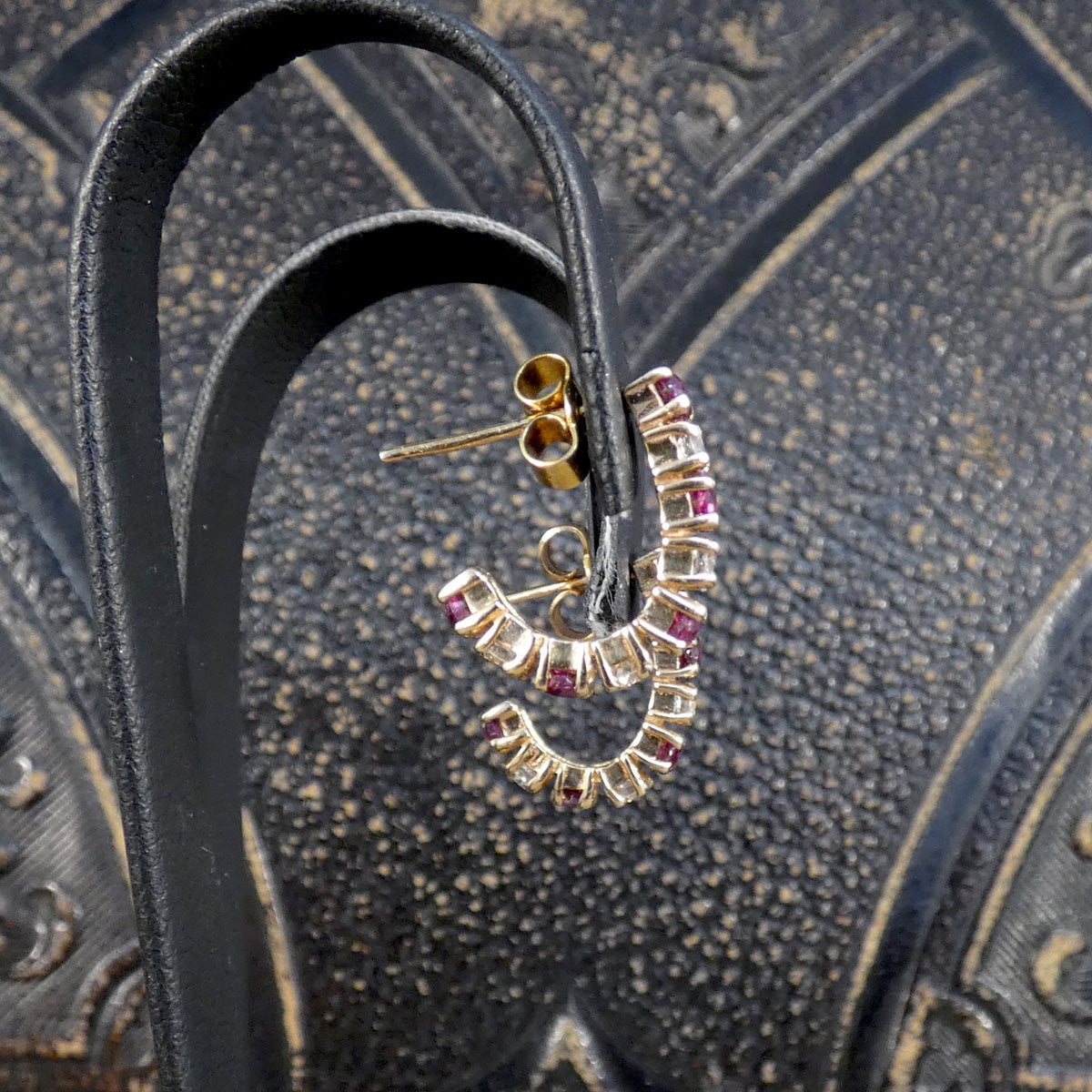 Ruby and Diamond Huggie Earrings in Yellow Gold shown from the side to see the hug
