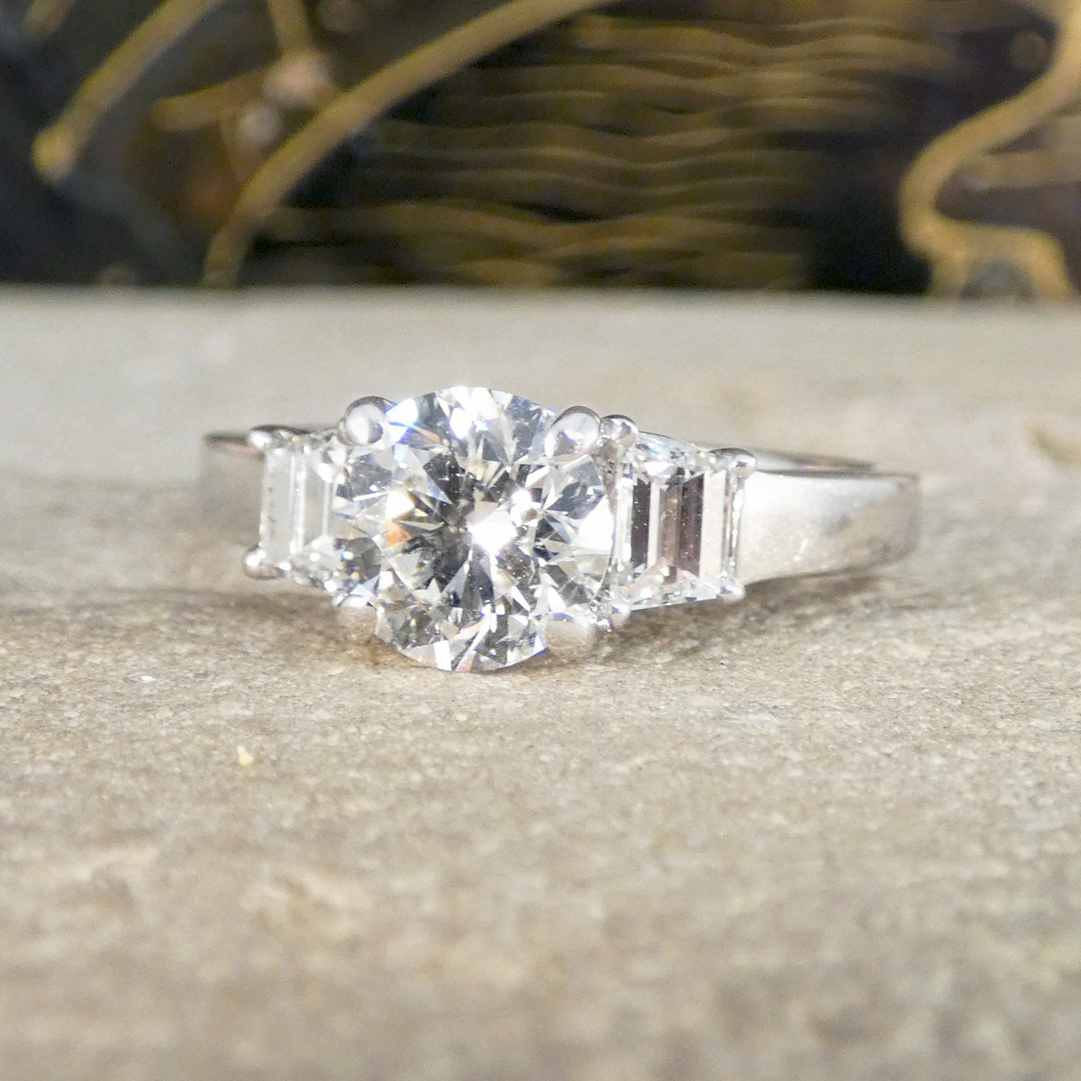 A brilliant cut and trapezoid cut Diamond three stone ring.