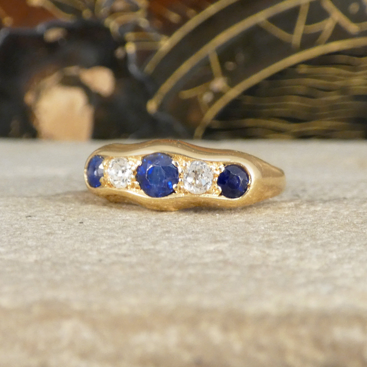 an antique sapphire and diamond five stone ring in 18ct yellow gold