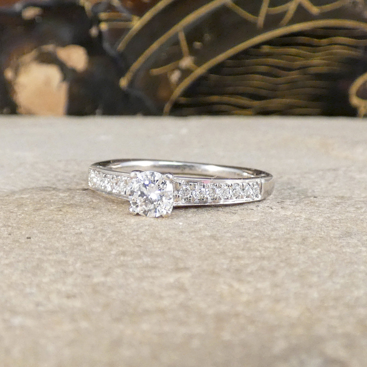 Diamond ring on a textured surface with a blurred background