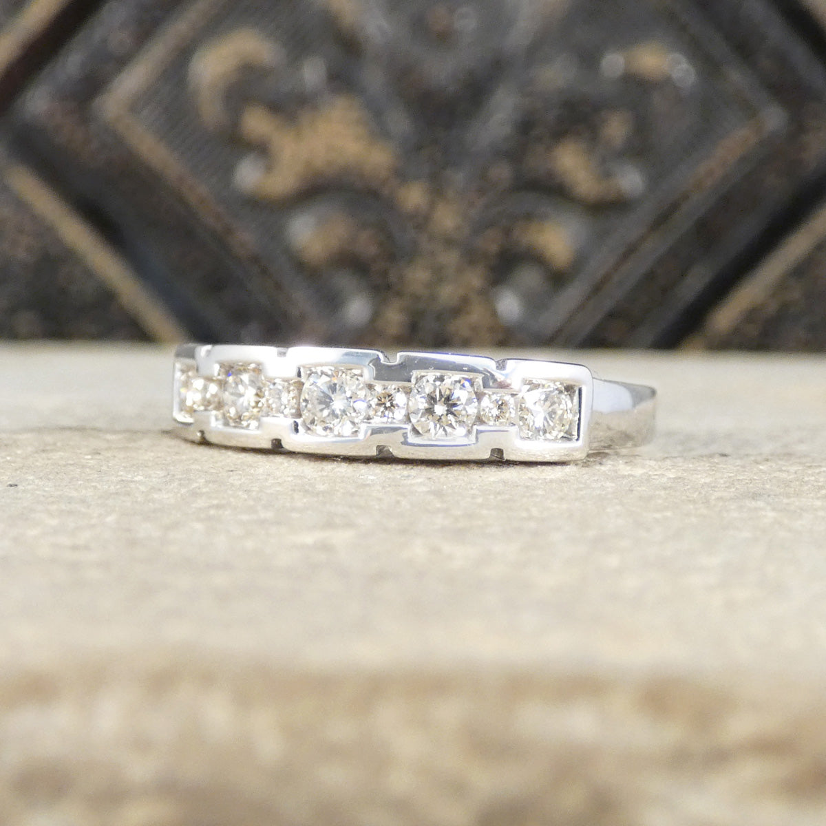 White Gold ring with diamonds on a textured surface