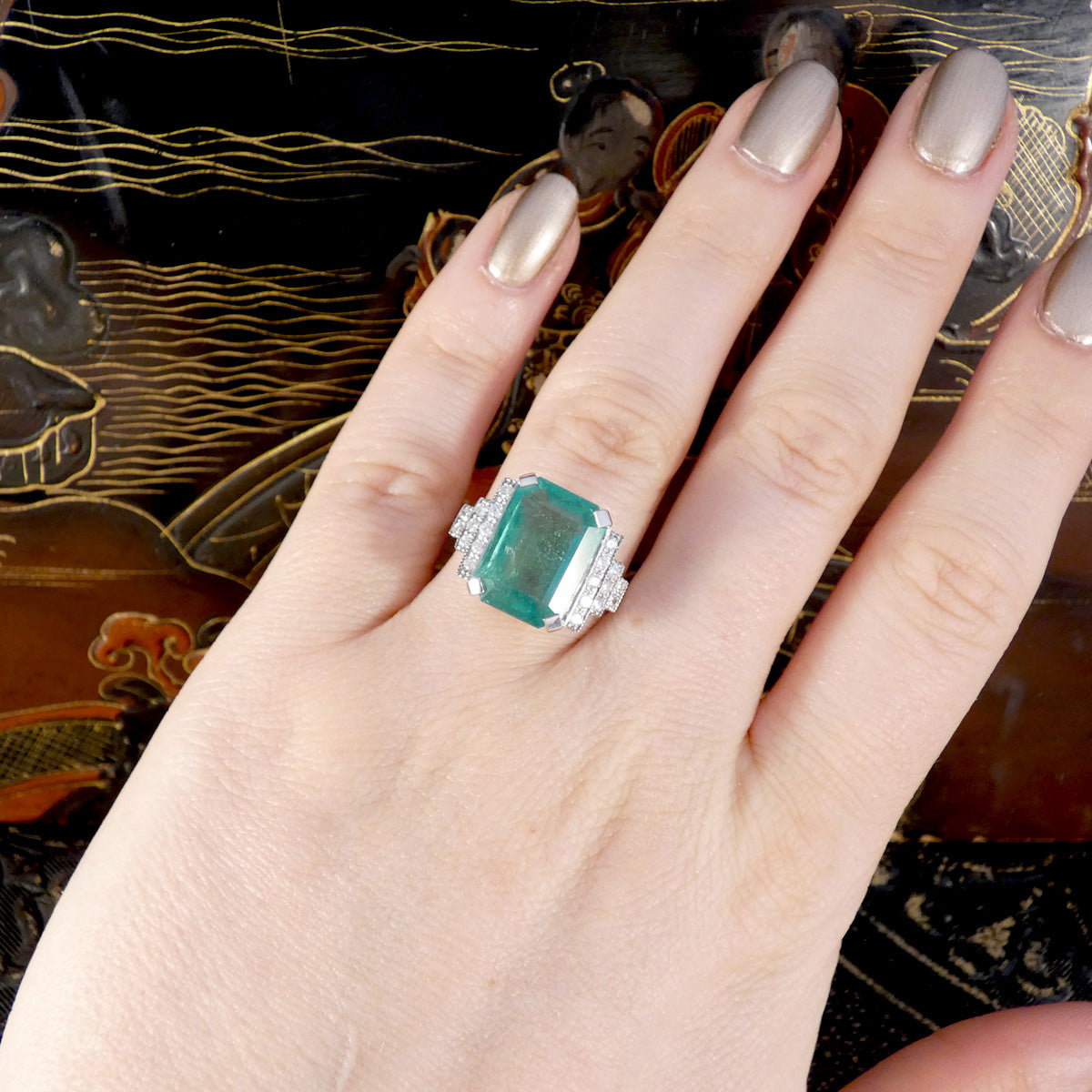 Gorgeous large Emerald and Diamond staged set shoulder ring in Platinum shown on the finger to see size and shape ratio.